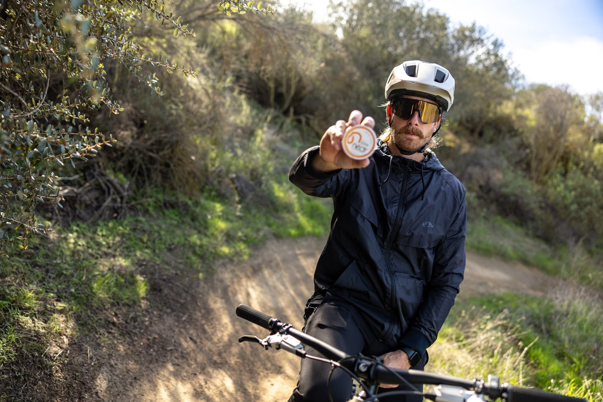 Customer holding a tin of Nectr Energy Nicotine-Free Pouches